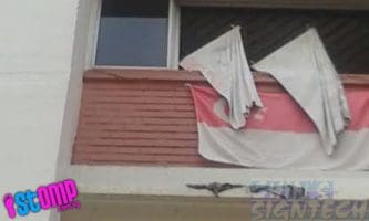 Faded Singapore flag hand at HDB