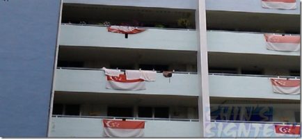 Faded screen printed Singapore flag hand at HDB