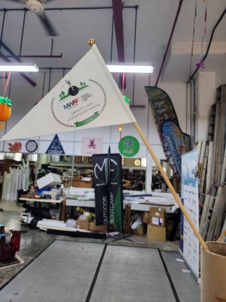 Hand waving flag double sided on wooden pole